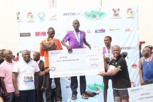 Gov. Ambode and Herbert Wigwe Presenting Abraham Kipton with the $50,000 cheque